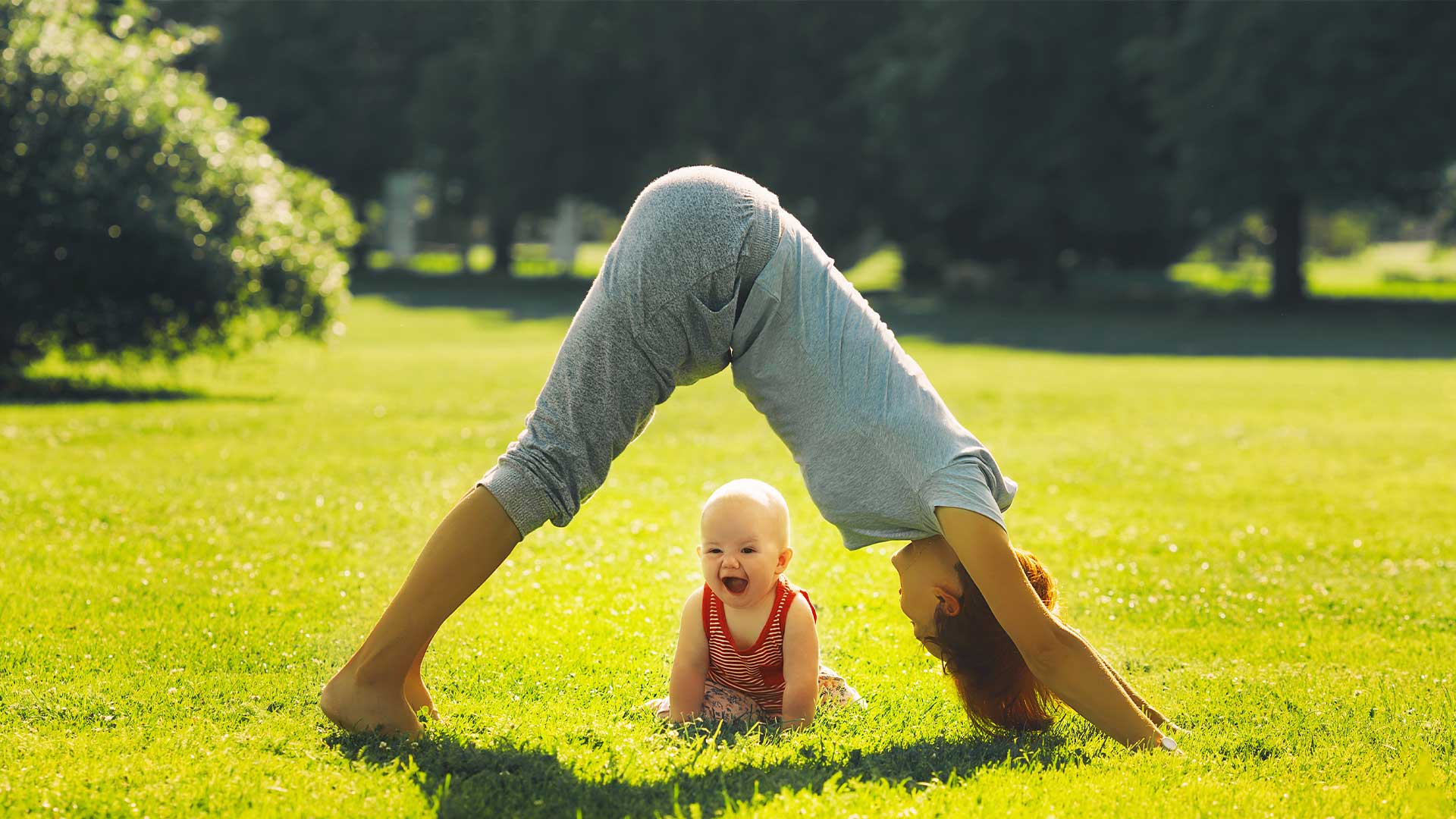 woman doing yoga with a baby